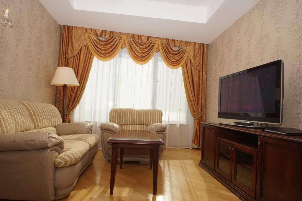 Grand Hotel Victory Aktau  Exterior foto A living room with a television